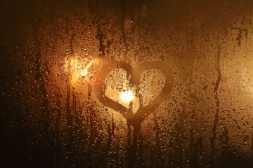 a heart drawn on a steamy glass 